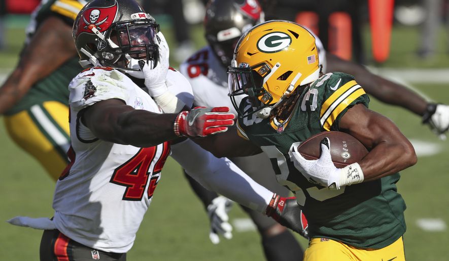 Green Bay Packers running back Aaron Jones (33) stiff arms Tampa Bay Buccaneers inside linebacker Devin White (45) during the first half of an NFL football game Sunday, Oct. 18, 2020, in Tampa, Fla. (AP Photo/Mark LoMoglio)