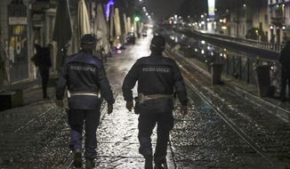 Two city police officers patrol the Navigli area, a popular evening spot of restaurants and pubs bordering canals in Milan, Italy, Thursday, Oct. 22, 2020. Authorities in regions including Italy&#39;s three largest cities have imposed curfews in a bid to slow the spread of COVID-19, as many of the cases in Lombardy&#39;s surging outbreak have occurred in Milan. On Thursday, an overnight curfew takes effect in the city, known for its lively night-time bar scene, and the rest of the region, as authorities try to slow the spread of the contagion. (AP Photo/Luca Bruno)