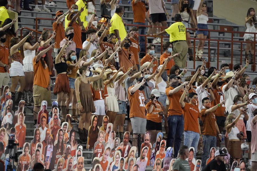 FILE - In this Saturday, Sept. 12, 2020, file photo, fans join in singing "The Eyes of Texas" after Texas defeated UTEP 59-3 in an NCAA college football game in Austin, Texas. Texas athletic director Chris Del Conte said Wednesday, Oct. 14, 2020, he expects players to “stand together as a unified group” to show appreciation for the school and fans during the playing of the school song “The Eyes of Texas” after games, but didn't say what will happen if they refuse. The song has exploded into a thorny controversy after several football players and other athletes said over the summer they no longer wanted to sing it because of its uncomfortable connections to racist elements of the school's past. (AP Photo/Chuck Burton, File)