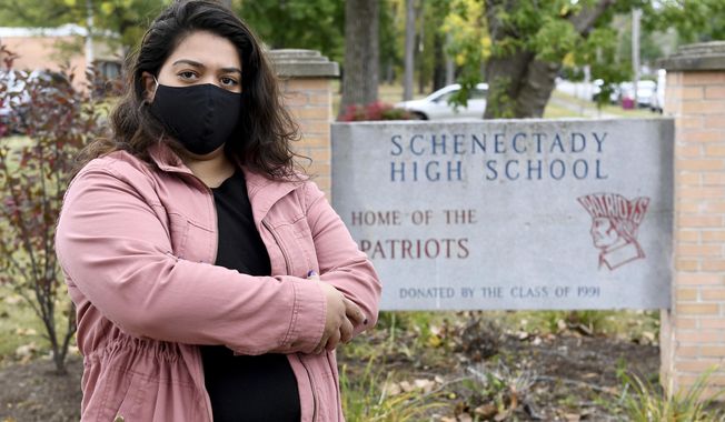 Kristina Negron poses for a photograph Tuesday, Sept. 29, 2020, in Schenectady, N.Y.  Negron was laid off from her job as an aide for a special education class at Schenectady High School due to budget cuts.  (AP Photo/Hans Pennink)