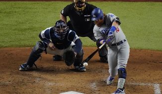 Los Angeles Dodgers&#39; Justin Turner hits a double against the Tampa Bay Rays during the third inning in Game 3 of the baseball World Series Friday, Oct. 23, 2020, in Arlington, Texas. (AP Photo/Sue Ogrocki)