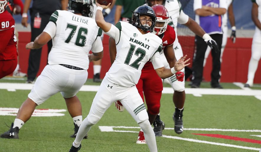 Hawaii quarterback Chevan Cordeiro passes downfield against Fresno State quarterback during the first half of an NCAA college football game in Fresno, Calif., Saturday, Oct. 24, 2020. (AP Photo/Gary Kazanjian)