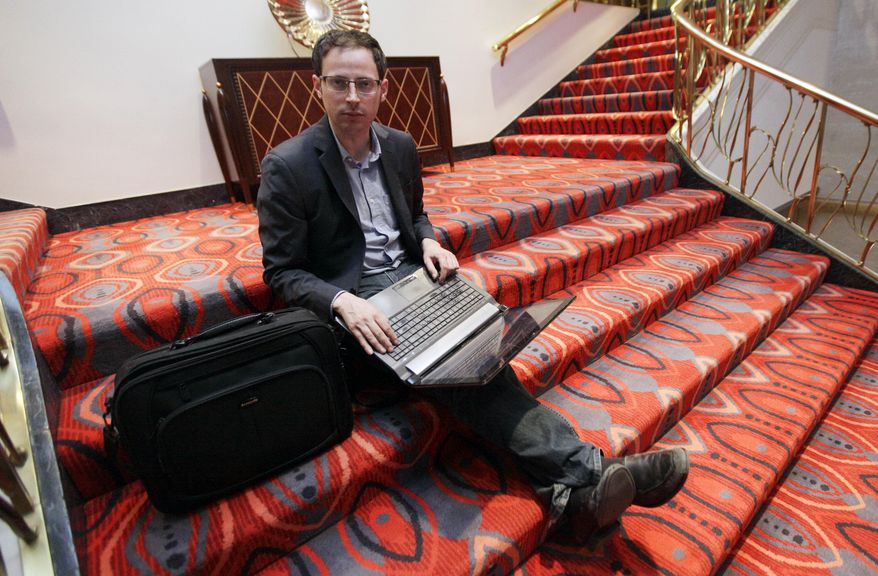 FILE - In this Friday Nov. 9, 2012 file photo, Nate Silver, statistician, unabashed numbers geek, author and creator of the much-read FiveThirtyEight blog at The New York Times, sits on the stairs at Allegro hotel in downtown Chicago. (AP Photo/Nam Y. Huh, File)