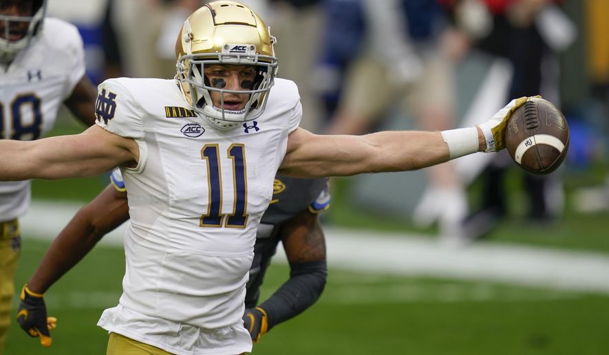 Notre Dame wide receiver Ben Skowronek (11) celebrates as he goes in the end zone past Pittsburgh defensive back A.J. Woods (25) for a touchdown after making a catch during the first half of an NCAA college football game, Saturday, Oct. 24, 2020, in Pittsburgh. (AP Photo/Keith Srakocic)