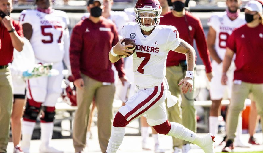 Oklahoma quarterback Spencer Rattler (7) carries the ball during the first half of an NCAA college football game against TCU, Saturday, Oct. 24, 2020, in Fort Worth, Texas. (AP Photo/Brandon Wade)