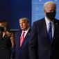 First lady Melania Trump, left, and President Donald Trump, center, remain on stage as Democratic presidential candidate former Vice President Joe Biden, right, walks away at the conclusion of the second and final presidential debate Thursday, Oct. 22, 2020, at Belmont University in Nashville, Tenn. (AP Photo/Julio Cortez)