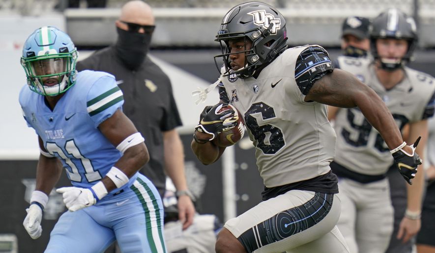 Central Florida wide receiver Marlon Williams (6) runs past Tulane safety Larry Brooks (31) on his way to a 54-yard touchdown on a pass play during the first half of an NCAA college football game, Saturday, Oct. 24, 2020, in Orlando, Fla. (AP Photo/John Raoux)