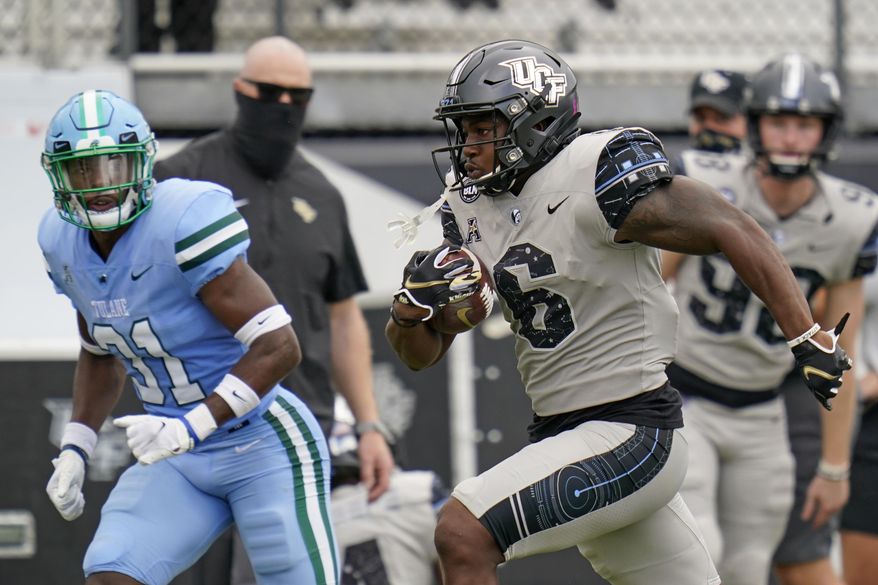 Central Florida wide receiver Marlon Williams (6) runs past Tulane safety Larry Brooks (31) on his way to a 54-yard touchdown on a pass play during the first half of an NCAA college football game, Saturday, Oct. 24, 2020, in Orlando, Fla. (AP Photo/John Raoux)