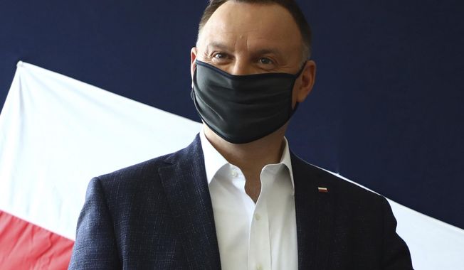 File—File picture taken June 28, 2020 shows Poland&#x27;s President Andrzej Duda casting his vote during presidential election in Krakow, Poland. Duda was tested positive on Corona. (AP Photo/Beata Zawrzal, file)
