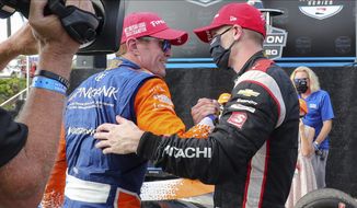 Josef Newgarden, right, congratulates Scott Dixon on the NTT IndyCar Series Championship following an IndyCar auto race Sunday, Oct. 25, 2020, in St. Petersburg, Fla. (AP Photo/Mike Carlson)
