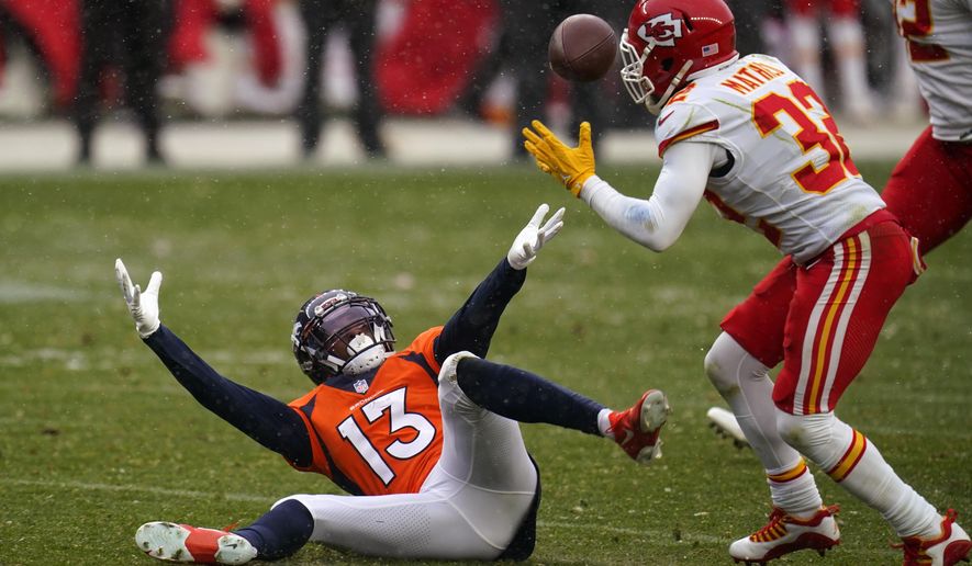 Denver Broncos wide receiver K.J. Hamler (13) falls as Kansas City Chiefs strong safety Tyrann Mathieu intercepts a pass during the second half of an NFL football game Sunday, Oct. 25, 2020, in Denver. (AP Photo/Jack Dempsey)