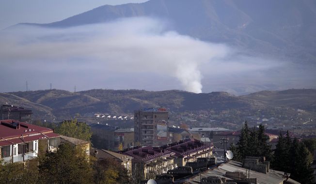 Smoke rises after shelling by Azerbaijan&#x27;s artillery during a military conflict in Stepanakert, the separatist region of Nagorno-Karabakh, Saturday, Oct. 24, 2020. The heavy shelling forced residents of Stepanakert, the regional capital of Nagorno-Karabakh, into shelters, as emergency teams rushed to extinguish fires. Nagorno-Karabakh authorities said other towns in the region were also targeted by Azerbaijani artillery fire. (AP Photo)