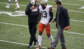 CORRECTS TO FIRST HALF - Cleveland Browns wide receiver Odell Beckham Jr. (13) is helped off the field in the first half of an NFL football game against the Cincinnati Bengals, Sunday, Oct. 25, 2020, in Cincinnati. (AP Photo/Michael Conroy)