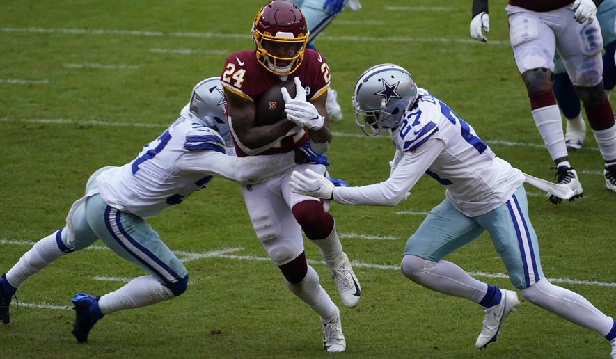 Dallas Cowboys safety Donovan Wilson (37) and cornerback Trevon Diggs (27) fail to stop Washington Football Team running back Antonio Gibson (24) from scoring a touchdown during the first half of an NFL football game, Sunday, Oct. 25, 2020, in Landover, Md. (AP Photo/Susan Walsh)