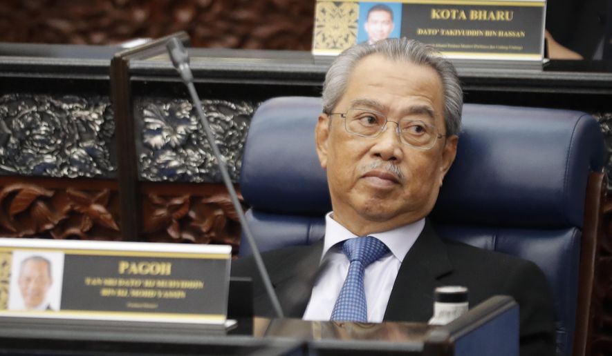 Malaysian Prime Minister Muhyiddin Yassin attends a parliament session at lower house in Kuala Lumpur, Malaysia, on July 13, 2020. Muhyiddin said Monday, Oct. 26, 2020 his government was prioritizing protecting people from COVID-19 amid a new outbreak after the king rejected an emergency proposal that critics saw as an undemocratic attempt to hold onto power. (AP Photo/Vincent Thian)