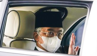 Malaysia&#39;s King Sultan Abdullah Sultan Ahmad Shah waves as he leaves National Palace in Kuala Lumpur, Malaysia, Sunday, Oct. 25, 2020. National Palace statement says Malay rulers has decided not to accede to Prime Minister Muhyiddin Yassin&#39;s request to declare a state of emergency. (AP Photo/Vincent Thian)