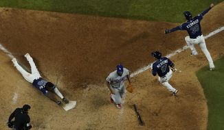 Tampa Bay Rays&#39; Randy Arozarena touches after scoring the winning run against the Los Angeles Dodgers in Game 4 of the baseball World Series Saturday, Oct. 24, 2020, in Arlington, Texas. Rays defeated the Dodgers 8-7 to tie the series 2-2 games. (AP Photo/David J. Phillip)