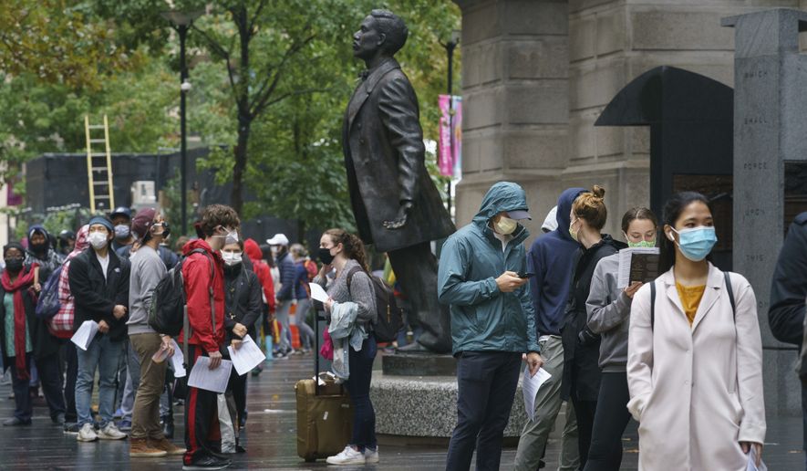 Angie People waiting in line to vote at City Hall in Philadelphia, Monday, Oct. 26, 2020. (Jessica Griffin/The Philadelphia Inquirer via AP)