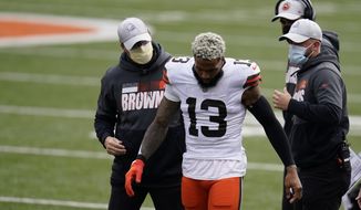 Cleveland Browns&#x27; Odell Beckham Jr. (13) leaves the field after being injured during the first half of an NFL football game against the Cincinnati Bengals, Sunday, Oct. 25, 2020, in Cincinnati. Browns star wide receiver Odell Beckham Jr. will miss the rest of the season after tearing a knee ligament during Sunday&#x27;s 37-34 win at Cincinnati. (AP Photo/Michael Conroy)