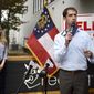 FILE - In this Oct. 12, 2020, file photo, Sen. Tom Cotton, R-Ark., right, speaks during a campaign event for Sen. Kelly Loeffler, R-Ga., left, at the Recteq facility in Evans, Ga. Six years after being elected in an expensive and heated race, Republican Sen. Tom Cotton is on the ballot again and he&#39;s campaigning hard — just not in Arkansas. (Michael Holahan/The Augusta Chronicle via AP, File)
