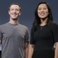 Behind a $350 million donation from Facebook CEO Mark Zuckerberg and his wife, Priscilla Chan, a nonprofit is doling out grants to Georgia state and local election officials for the Jan. 5 Senate runoffs. (AP Photo/Jeff Chiu, File)
