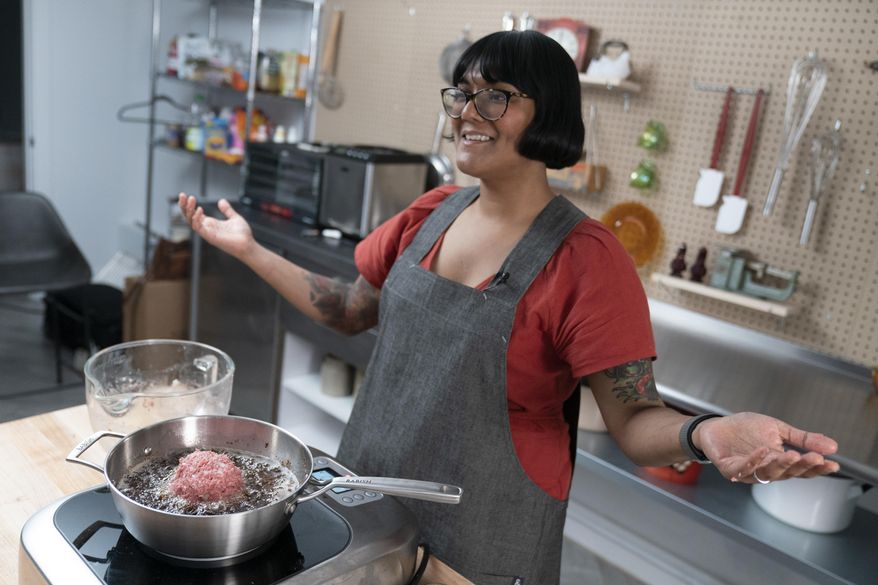In this Oct. 7, 2020 photo, chef Sohla El-Waylly prepares Swedish meatballs during a taping of "Stump Sohla," in New York. El-Waylly became a familiar face on YouTube as a standout on Bon Appetit's test kitchen channel. But during the nationwide racial reckoning following the police killing of George Floyd, she was among members of the test kitchen who accused the channel's owner, Conde Nast, of discriminatory practices. She departed Bon Appetit in August after failed negotiations. Her new show is her own, pushing her to deploy her talent, charm and encyclopedic culinary chops to solve challenges. (AP Photo/Mary Altaffer)