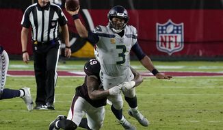 Seattle Seahawks quarterback Russell Wilson (3) gets the throw off as Arizona Cardinals linebacker Kylie Fitts makes the hit during the second half of an NFL football game, Sunday, Oct. 25, 2020, in Glendale, Ariz. (AP Photo/Rick Scuteri)