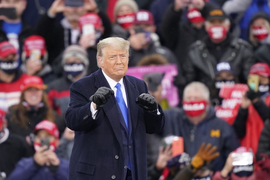 President Donald Trump gestures after speaking during a campaign event, Tuesday, Oct. 27, 2020, in Lansing, Mich. (AP Photo/Carlos Osorio)