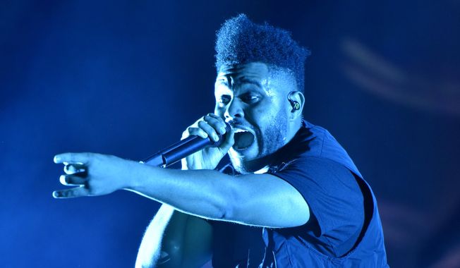The Weeknd performs on day three at Lollapalooza in Chicago on Aug 4, 2018.  The Weeknd was nominated for eight American Music Awards on Monday. The 2020 American Music Awards will air live on Nov. 22 on ABC. (Photo by Rob Grabowski/Invision/AP, File) **FILE**