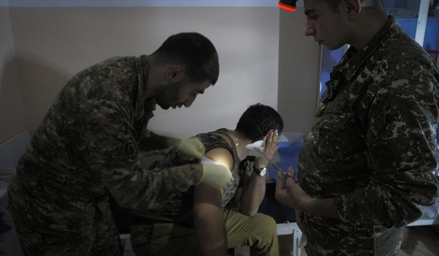 An Armenian wounded soldier receives treatment in a military hospital near the frontline in the separatist region of Nagorno-Karabakh, Sunday, Oct. 25, 2020. Armenia and Azerbaijan have accused each other of violating the new U.S.-brokered cease-fire aimed to halt the fighting over the separatist region of Nagorno-Karabakh. (AP Photo)