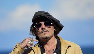 FILE - In this file photo dated Sunday, Sept. 20, 2020, US actor and film producer Johnny Deep during the photocall for his film &amp;quot;Crock of Gold: A Few Rounds with Shane Macgoman&amp;quot; at the 68th San Sebastian Film Festival, in San Sebastian, northern Spain.  Britain’s judicial office said Tuesday Oct. 27, 2020, that judge Andrew Nicol will deliver his verdict in writing on Nov. 2, ruling on whether Johnny Depp was libelled by a tabloid newspaper that branded him a wife-beater. (AP Photo/Alvaro Barrientos, FILE)