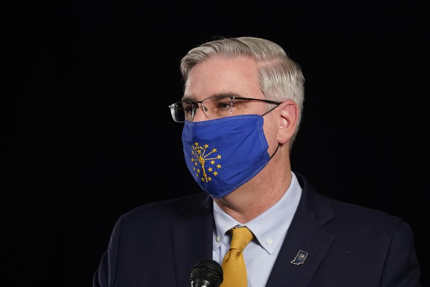 Indiana Republican Gov. Eric Holcomb participates in the Indiana Gubernatorial debate with Democrat Woody Myers and Libertarian Donald Rainwater, Tuesday, Oct. 27, 2020, in Indianapolis. The candidates were in separate studios to allow for social distancing guidelines. (AP Photo/Darron Cummings)