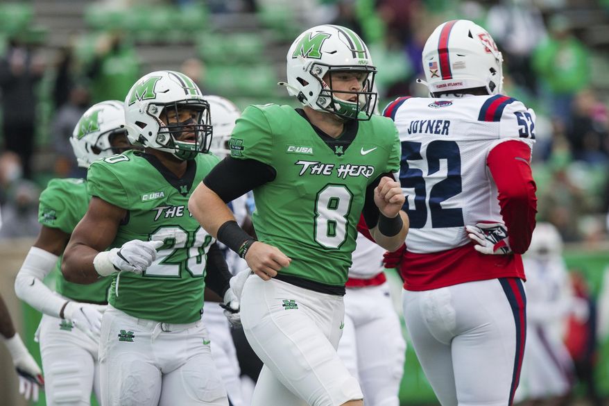 Marshall quarterback Grant Wells (8) and running back Brenden Knox (20) head to the sideline after a touchdown as the Herd takes on Florida Atlantic during an NCAA college football game at Joan C. Edwards Stadium, Saturday, Oct. 24, 2020, in Huntington, W.Va. (Sholten Singer/The Herald-Dispatch via AP)
