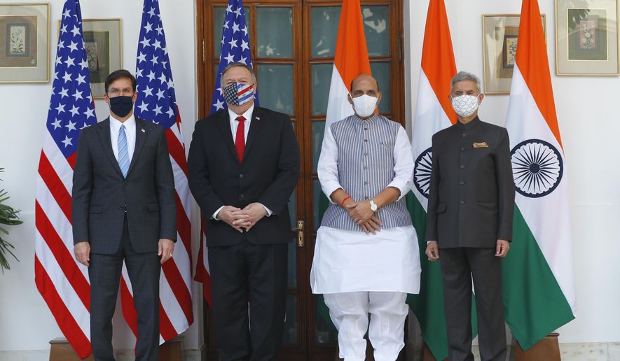 U.S. Secretary of State Mike Pompeo, second left, and Secretary of Defence Mark Esper, left, stand for photographs with Indian Foreign Minister Subrahmanyam Jaishankar, right, and Defence Minister Rajnath Singh ahead of their meeting at Hyderabad House in New Delhi, India, Tuesday, Oct. 27, 2020. In talks on Tuesday with their Indian counterparts, Pompeo and Esper are to sign an agreement expanding military satellite information sharing and highlight strategic cooperation between Washington and New Delhi with an eye toward countering China. (Adnan Abidi/Pool via AP)