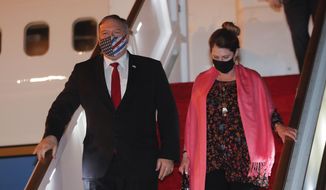 U.S. Secretary of State Mike Pompeo, and his wife Susan disembark from an aircraft upon their arrival at the airport in Colombo, Sri Lanka, Tuesday, Oct. 27, 2020. (AP Photo/Eranga Jayawardena, Pool)