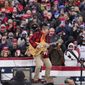Musician Ted Nugent plays the national anthem before a President Donald Trump campaign event, Tuesday, Oct. 27, 2020, in Lansing, Mich. (AP Photo/Carlos Osorio)