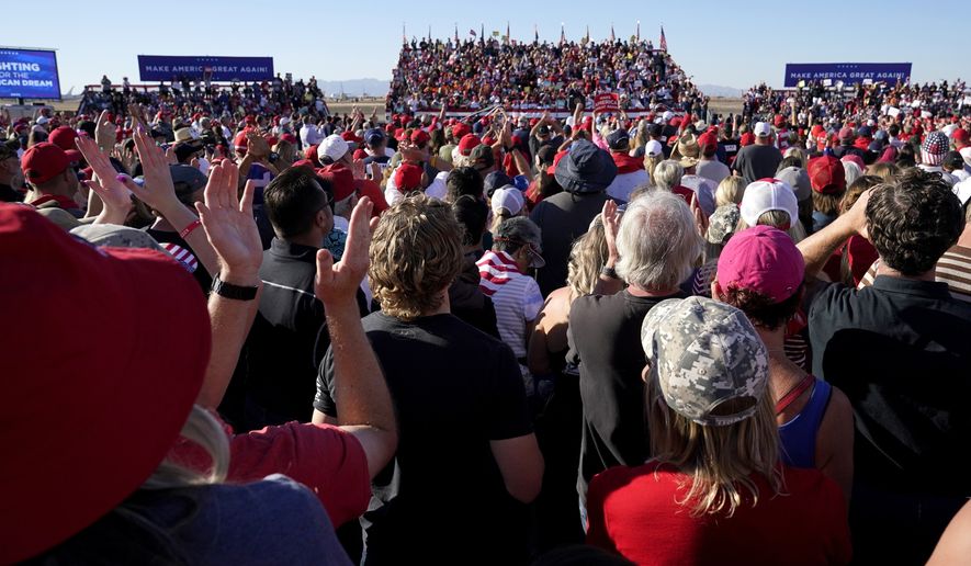 Supporters of President Donald Trump applaud as he speaks at a campaign rally at Phoenix Goodyear Airport Wednesday, Oct. 28, 2020, in Goodyear, Ariz. (AP Photo/Ross D. Franklin)