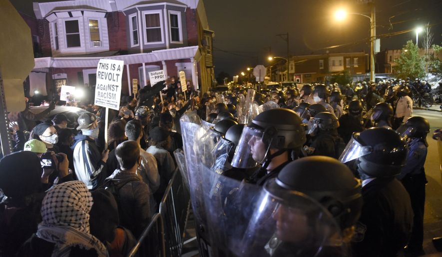 Protesters face off with police during a demonstration Tuesday, Oct. 27, 2020, in Philadelphia. Hundreds of demonstrators marched in West Philadelphia over the death of Walter Wallace Jr., a Black man who was killed by police in Philadelphia on Monday. (AP Photo/Michael Perez)