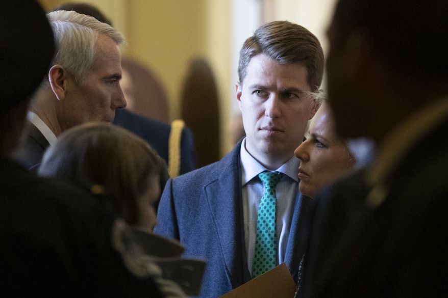 In this March 5, 2019, photo, Sen. Rob Portman, R-Ohio, left, talks with Homeland Security Secretary Kirstjen Nielsen, right, and her chief of staff Miles Taylor depart after the Republican Caucus luncheon on Capitol Hill in Washington. Taylor who penned a scathing anti-Trump op-ed and book under the pen name Anonymous made his identify public Wednesday, Oct. 28, 2020.  (AP Photo/Alex Brandon)