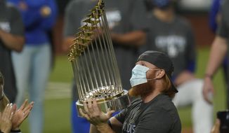 Los Angeles Dodgers third baseman Justin Turner celebrates with the trophy after defeating the Tampa Bay Rays 3-1 to win the baseball World Series in Game 6 Tuesday, Oct. 27, 2020, in Arlington, Texas. (AP Photo/Eric Gay)