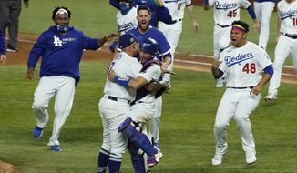 Los Angeles Dodgers celebrate after defeating the Tampa Bay Rays 3-1 to win the baseball World Series in Game 6 Tuesday, Oct. 27, 2020, in Arlington, Texas. (AP Photo/Tony Gutierrez)