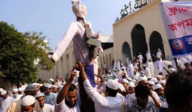 Supporters of Islami Oikya Jote, an Islamist political party, hold up an effigy representing French President Emmanuel Macron during a protest against the publishing of caricatures of the Prophet Muhammad they deem blasphemous, in Dhaka, Bangladesh, Wednesday, Oct. 28, 2020. Muslims in the Middle East and beyond on Monday called for boycotts of French products and for protests over the caricatures, but Macron has vowed his country will not back down from its secular ideals and defense of free speech. Posters read &amp;quot;France is the enemy of humanity. World citizens fight back.&amp;quot; second left, &amp;quot;Muslims of the world stand against insults to the prophet,&amp;quot; third right and &amp;quot;Stop buying products from France. In the name of the Prophet,&amp;quot; left. (AP Photo/Mahmud Hossain Opu)