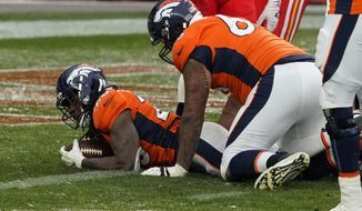 Denver Broncos running back Melvin Gordon, left, scores a touchdown during the second half of an NFL football game against the Kansas City Chiefs, Sunday, Oct. 25, 2020, in Denver. (AP Photo/Jack Dempsey)