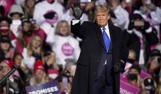 President Donald Trump waves after speaking at a campaign rally in Omaha, Neb., Tuesday, Oct. 27, 2020. (AP Photo/Nati Harnik)