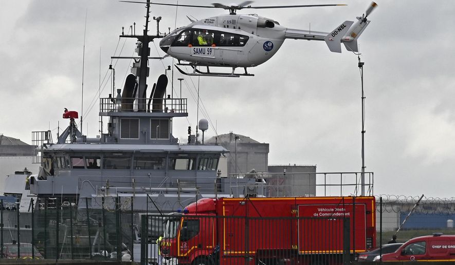 A French rescue helicopter lands close to a rescue vessel in Dunkirk, northern France, Tuesday, Oct. 27, 2020 during a search operation after four migrants, including a 5-year-old and 8-year-old child died Tuesday when their boat capsized while they and other migrants tried to cross the English Channel to Britain, French authorities said. Fifteen migrants have been saved so far and rescue and search operations are still under way, according to the regional administration for the Nord region. (AP Photo)