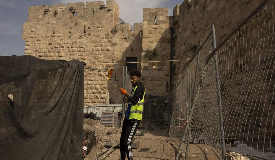A worker places netting at a construction site inside the Tower of David Museum in the Old City of Jerusalem, Wednesday, Oct. 28, 2020. Jerusalem&#x27;s ancient citadel is devoid of tourists due to the pandemic and undergoing a massive restoration and conservation project. The Tower of David, the Old City&#x27;s iconic fortress, contains remnants of successive fortifications built one atop the other stretching back over 2,500 years. (AP Photo/Maya Alleruzzo)
