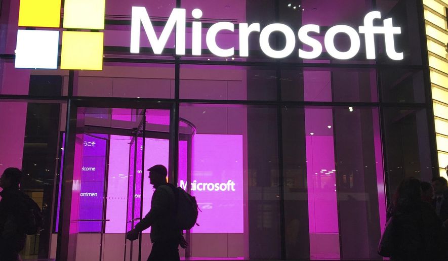 FILE - In this Nov. 10, 2016, photo, people walk near a Microsoft office in New York.  Microsoft says Iranian hackers have posed as conference organizers in Germany and Saudi Arabia in an attempt to spy on “high-profile” people using spoofed email invitations. The tech company said Wednesday, Oct. 28, 2020, it detected attempts by the hacking group it calls Phosphorus to trick former government officials, policy experts and academics.  (AP Photo/Swayne B. Hall)
