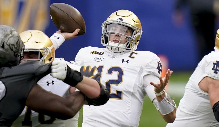Notre Dame quarterback Ian Book (12) passes against Pittsburgh during the first half of an NCAA college football game, Saturday, Oct. 24, 2020, in Pittsburgh. (AP Photo/Keith Srakocic)