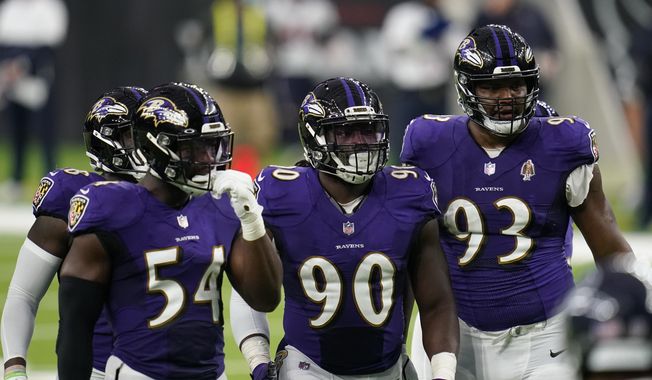 Baltimore Ravens defenders Pernell McPhee (90) Calais Campbell (93) prepare for the next play during an NFL football game against the Houston Texans, Sunday, Sept. 20, 2020, in Houston. In the midst of an NFL season that is course to set records for the most points and touchdowns, the Baltimore Ravens and Pittsburgh Steelers are winning on the strength of their defense. (AP Photo/Matt Patterson)