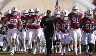 FILE - In this Nov. 23, 2019, file photo, Stanford head coach David Shaw, center, leads his team onto the field before an NCAA college football game against California in Stanford, Calif. Shaw could look at it as Stanford and the Pac-12 are behind the rest of the country with a late start to the football season, which will end up being a seven-game, all-conference schedule if all goes as planned. (AP Photo/Tony Avelar, File)
